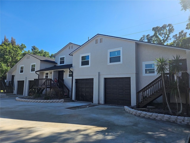 5802 Mohr Loop Unit 5802-5804-5806-5808, Tampa, FL 33615 - view of front of house with stairway, a garage, concrete driveway, and stucco siding