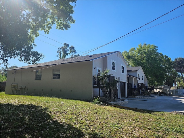 5802 Mohr Loop Unit 5802-5804-5806-5808, Tampa, FL 33615 - view of property exterior featuring stucco siding, stairs, and a yard