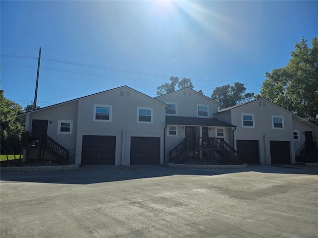 5802 Mohr Loop Unit 5802-5804-5806-5808, Tampa, FL 33615 - view of front facade featuring stairs, an attached garage, driveway, and stucco siding