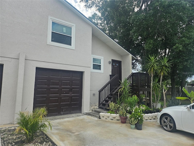 5802 Mohr Loop Unit 5802-5804-5806-5808, Tampa, FL 33615 - view of front facade with a garage, stucco siding, and concrete driveway