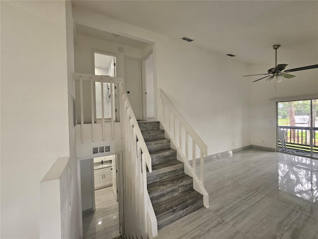 5802 Mohr Loop Unit 5802-5804-5806-5808, Tampa, FL 33615 - staircase with ceiling fan, a high ceiling, and baseboards