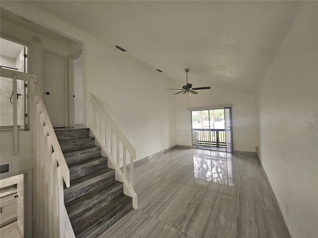 5802 Mohr Loop Unit 5802-5804-5806-5808, Tampa, FL 33615 - unfurnished living room featuring a ceiling fan, vaulted ceiling, stairs, and baseboards