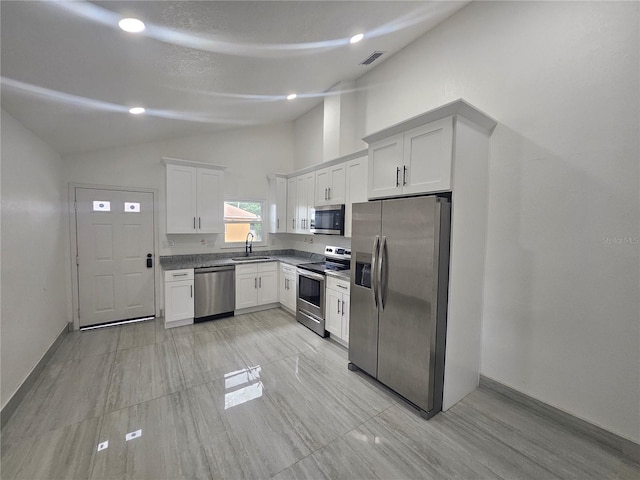 5802 Mohr Loop Unit 5802-5804-5806-5808, Tampa, FL 33615 - kitchen with stainless steel appliances, vaulted ceiling, a sink, white cabinetry, and dark countertops