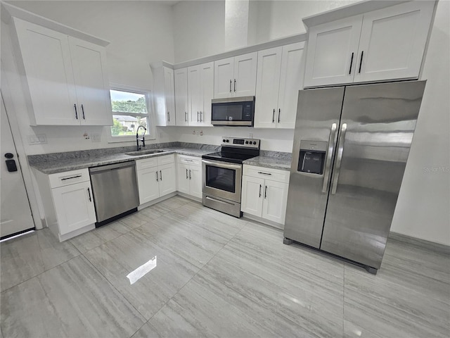 5802 Mohr Loop Unit 5802-5804-5806-5808, Tampa, FL 33615 - kitchen featuring appliances with stainless steel finishes, a sink, white cabinets, and stone counters