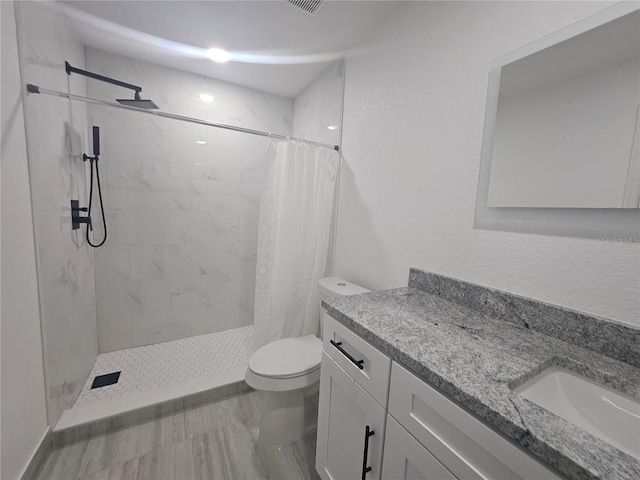 5802 Mohr Loop Unit 5802-5804-5806-5808, Tampa, FL 33615 - bathroom with toilet, vanity, a tile shower, and marble finish flooring