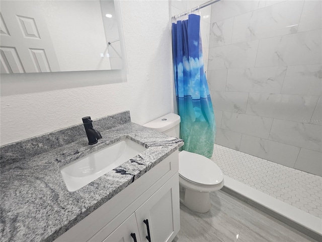 5802 Mohr Loop Unit 5802-5804-5806-5808, Tampa, FL 33615 - bathroom featuring toilet, vanity, a tile shower, and wood finished floors