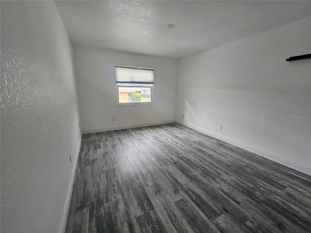 5802 Mohr Loop Unit 5802-5804-5806-5808, Tampa, FL 33615 - spare room featuring a textured wall, wood finished floors, baseboards, and a textured ceiling