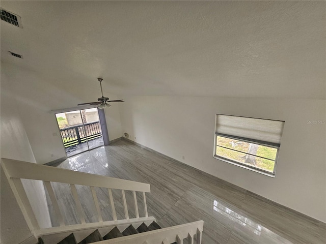 5802 Mohr Loop Unit 5802-5804-5806-5808, Tampa, FL 33615 - stairs featuring ceiling fan and a textured ceiling
