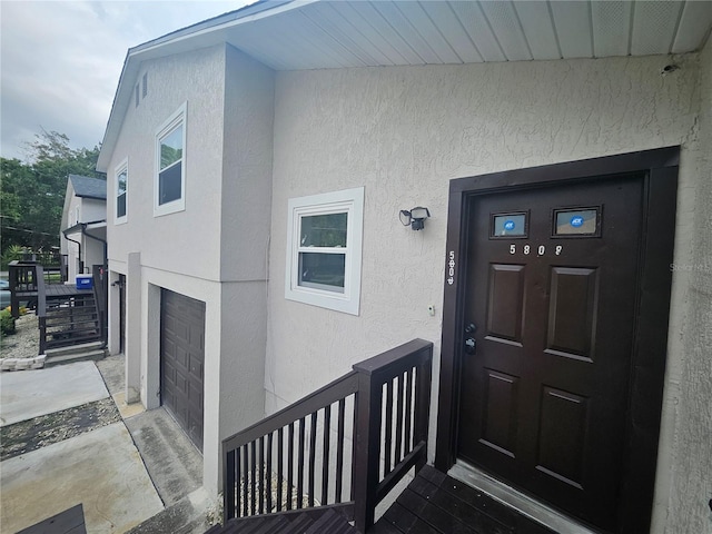 5802 Mohr Loop Unit 5802-5804-5806-5808, Tampa, FL 33615 - view of exterior entry featuring stucco siding and an attached garage