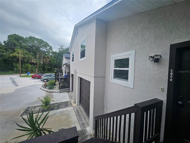 5802 Mohr Loop Unit 5802-5804-5806-5808, Tampa, FL 33615 - view of side of home featuring stucco siding and an attached garage