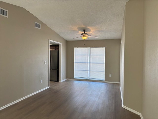 unfurnished room with dark hardwood / wood-style floors, ceiling fan, a textured ceiling, and vaulted ceiling