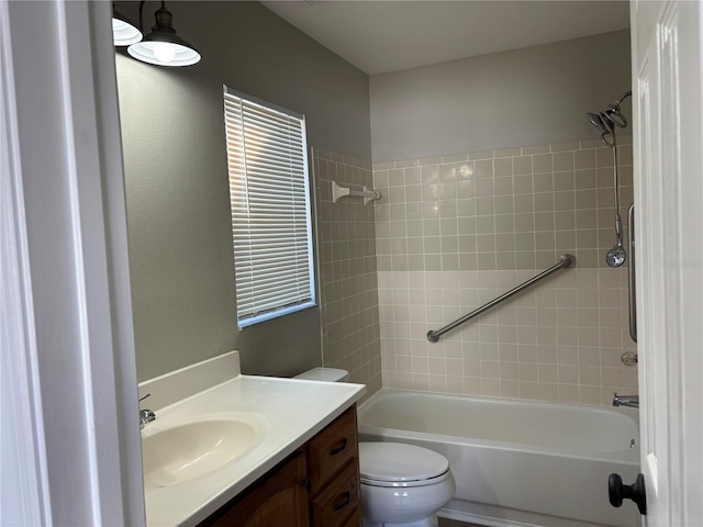 full bathroom featuring vanity, toilet, and tiled shower / bath