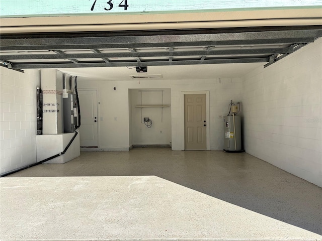 garage with electric water heater and a garage door opener