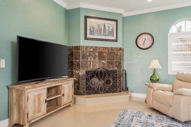 living room featuring light tile patterned floors, ornamental molding, a fireplace, and baseboards