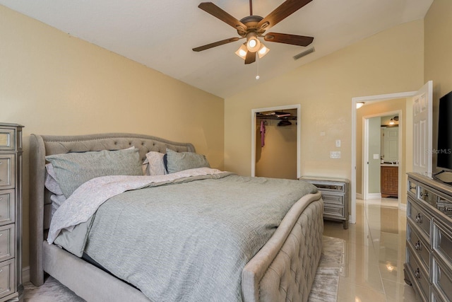 bedroom featuring ceiling fan, lofted ceiling, a walk in closet, a closet, and light tile patterned floors