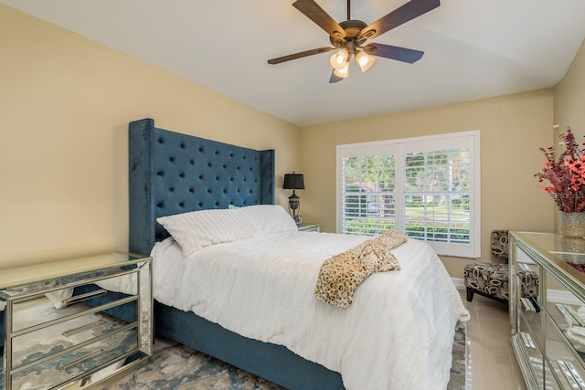 tiled bedroom featuring ceiling fan