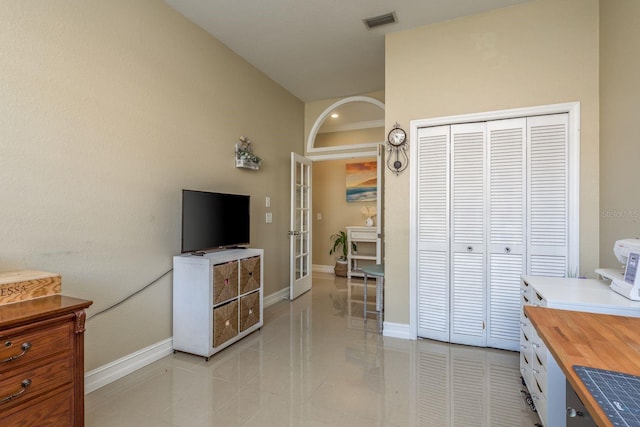 interior space with light tile patterned floors, visible vents, and baseboards