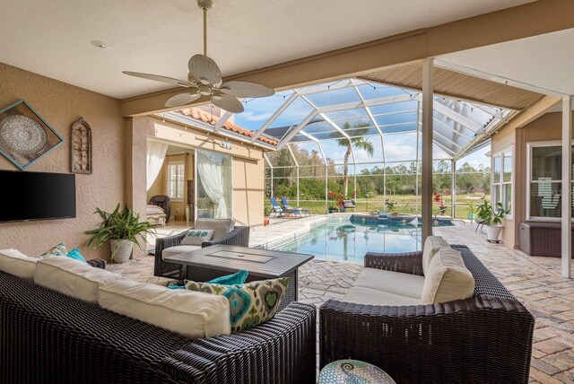 exterior space featuring a lanai, ceiling fan, and an outdoor hangout area