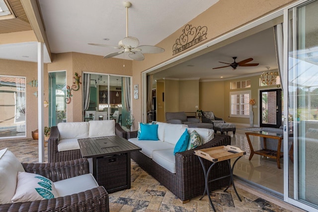 sunroom / solarium featuring ceiling fan