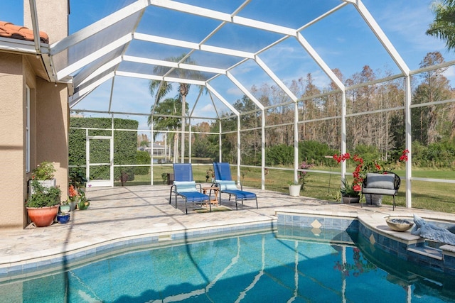 view of swimming pool with a patio area and a lanai