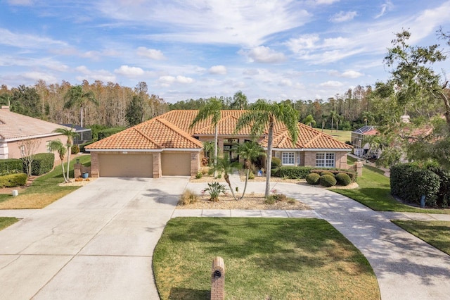 mediterranean / spanish house with concrete driveway, a tile roof, and a front lawn