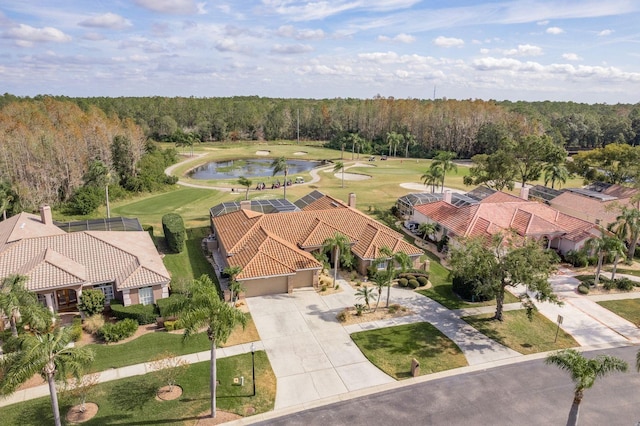 birds eye view of property with a view of trees