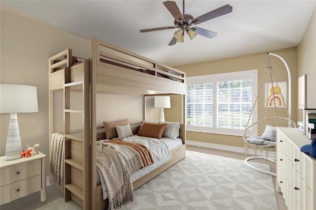 bedroom with baseboards and a ceiling fan