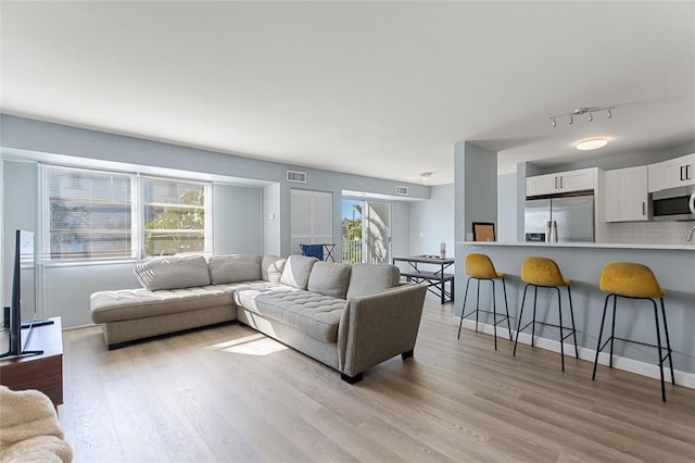 3315 58th Ave S Unit 210, Saint Petersburg, FL 33712 - living area with light wood-type flooring and track lighting
