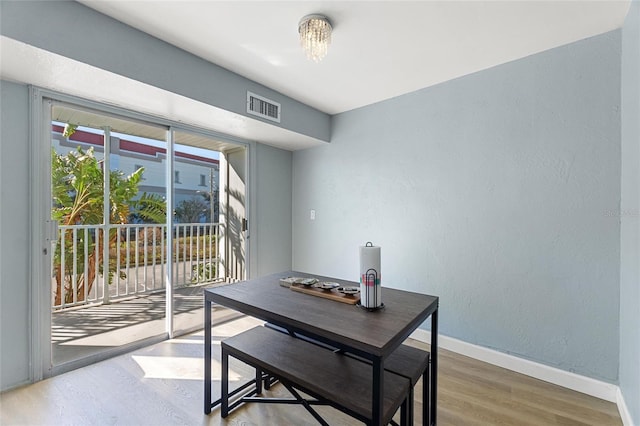 3315 58th Ave S Unit 210, Saint Petersburg, FL 33712 - dining room with wood finished floors, baseboards, and a textured wall