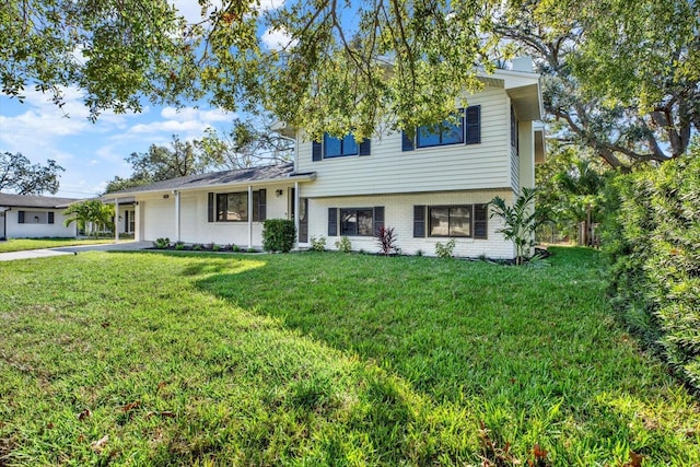 view of front of property with a garage and a front yard