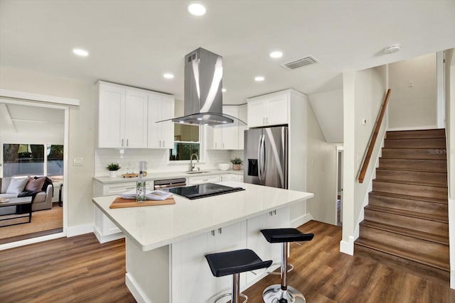 kitchen with a center island, dark wood-type flooring, sink, island range hood, and stainless steel appliances