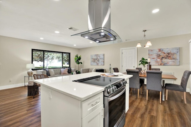 kitchen with white cabinetry, dark wood-type flooring, decorative light fixtures, stainless steel range with electric stovetop, and island range hood