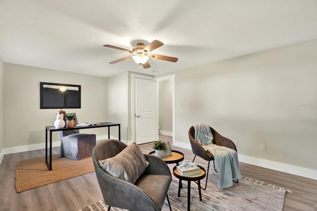 sitting room with hardwood / wood-style flooring and ceiling fan