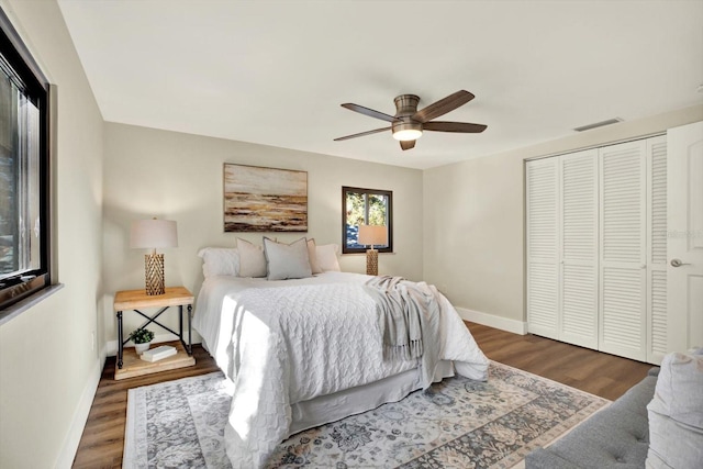 bedroom with a closet, ceiling fan, and dark wood-type flooring