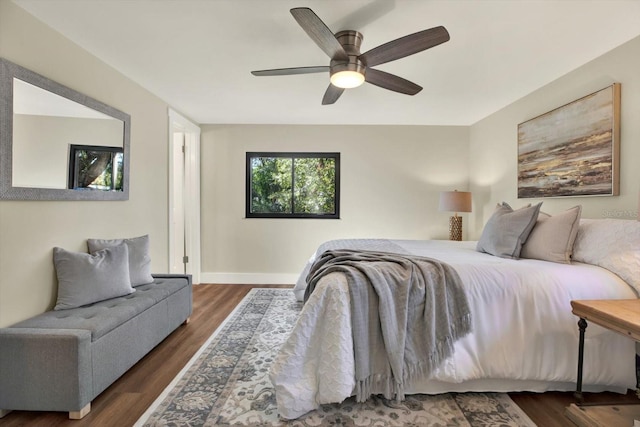 bedroom with dark hardwood / wood-style floors and ceiling fan