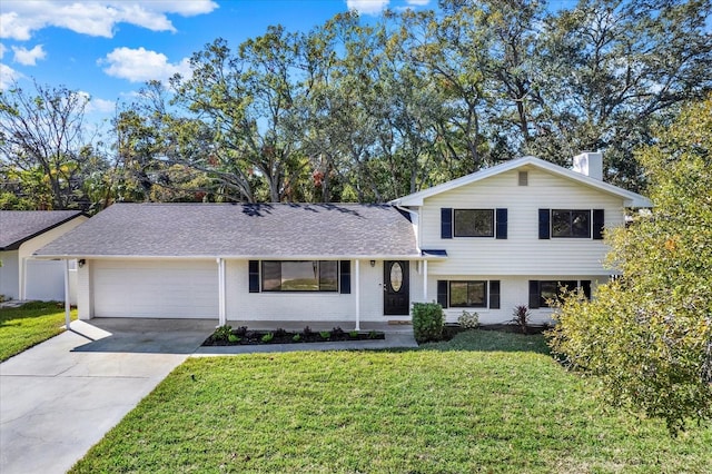 tri-level home with a front yard and a garage