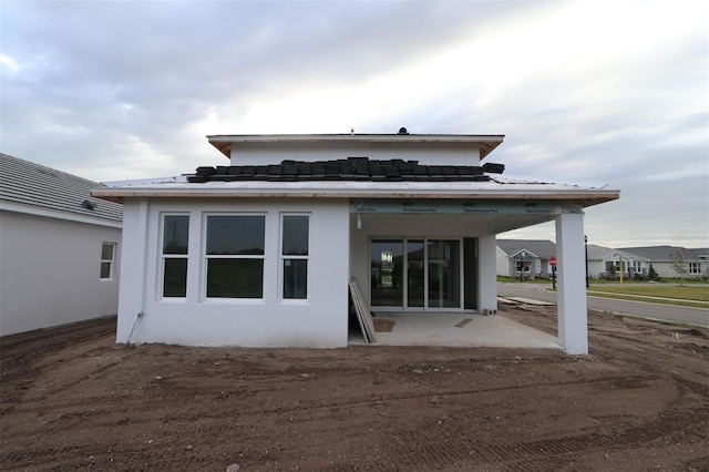 rear view of property with stucco siding