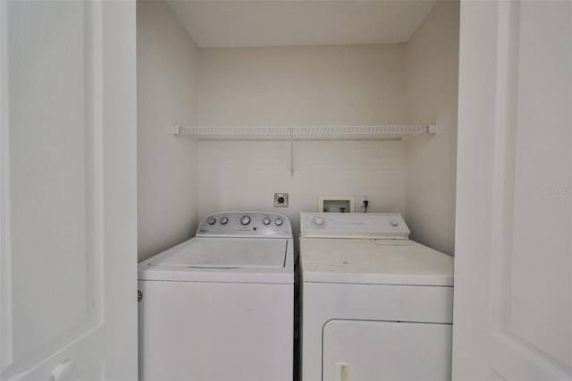 washroom with washing machine and clothes dryer