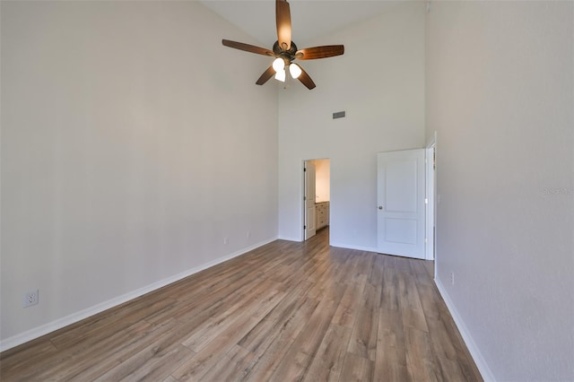 spare room with ceiling fan, light hardwood / wood-style floors, and high vaulted ceiling