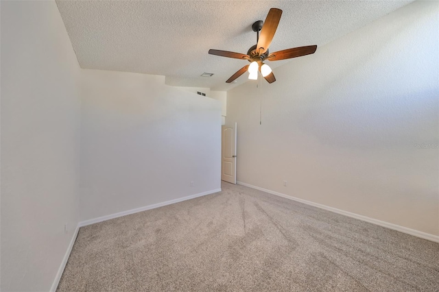 unfurnished room with ceiling fan, carpet, and a textured ceiling