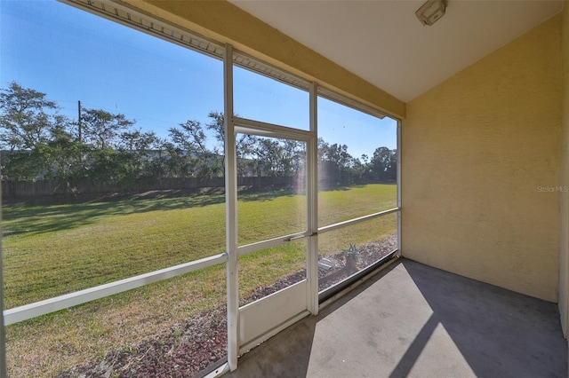 unfurnished sunroom with lofted ceiling