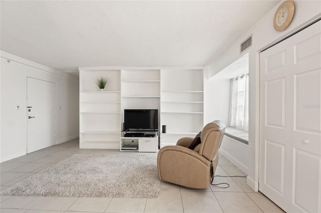 tiled living room with a textured ceiling