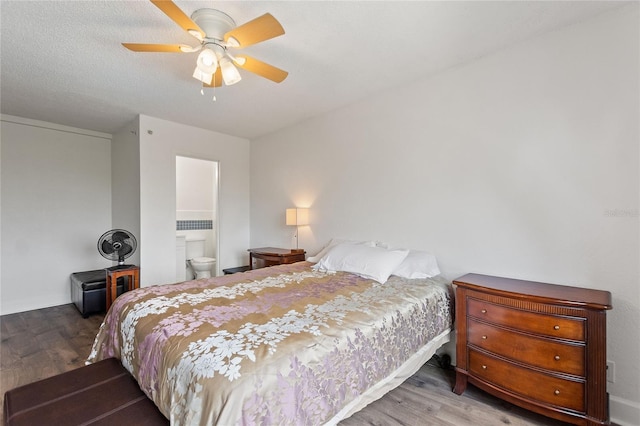 bedroom featuring hardwood / wood-style flooring, ceiling fan, ensuite bathroom, and a textured ceiling