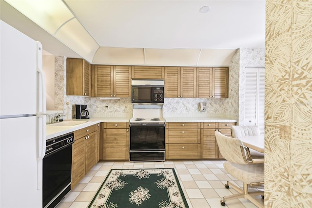 kitchen featuring black appliances, decorative backsplash, light tile patterned floors, and sink