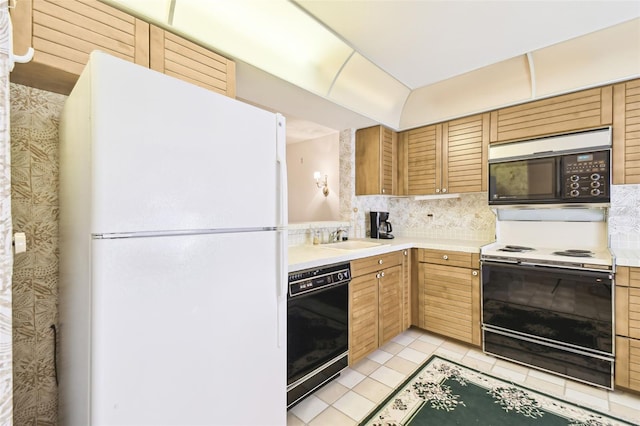 kitchen featuring black appliances, light tile patterned flooring, sink, and tasteful backsplash