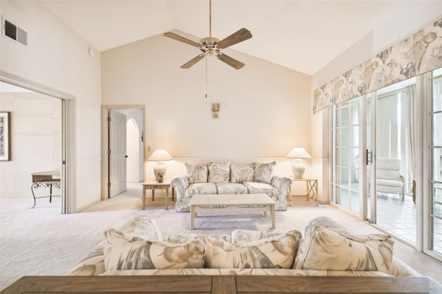 living room featuring ceiling fan, high vaulted ceiling, and light colored carpet