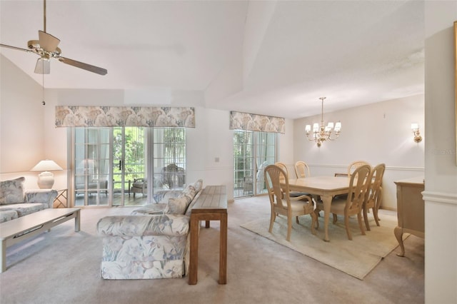 dining area featuring light colored carpet and ceiling fan with notable chandelier