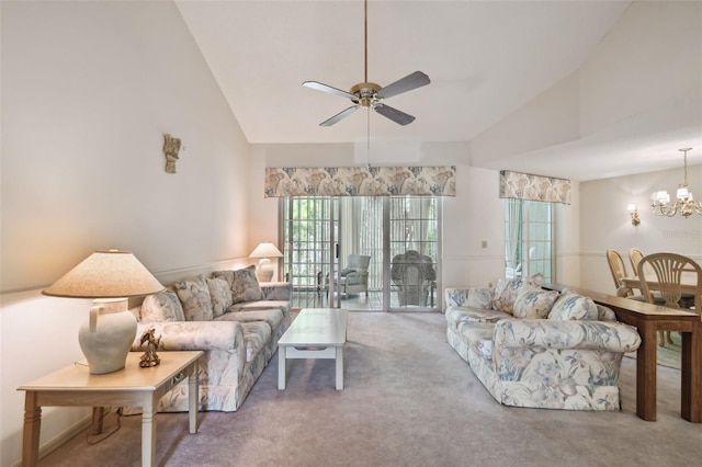 living room featuring carpet flooring, ceiling fan with notable chandelier, and high vaulted ceiling