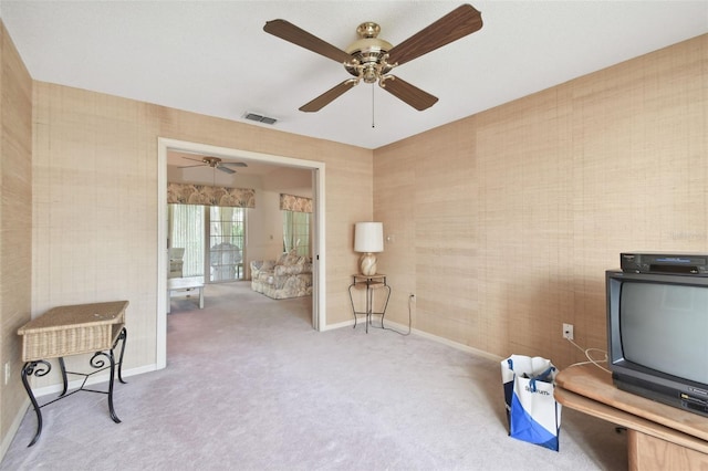 interior space with light colored carpet and ceiling fan