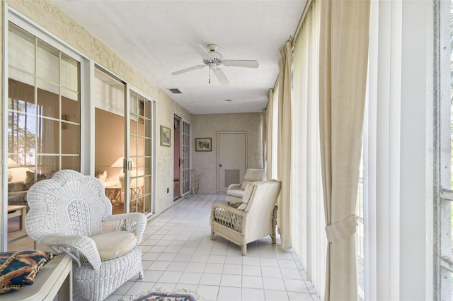 sunroom featuring ceiling fan